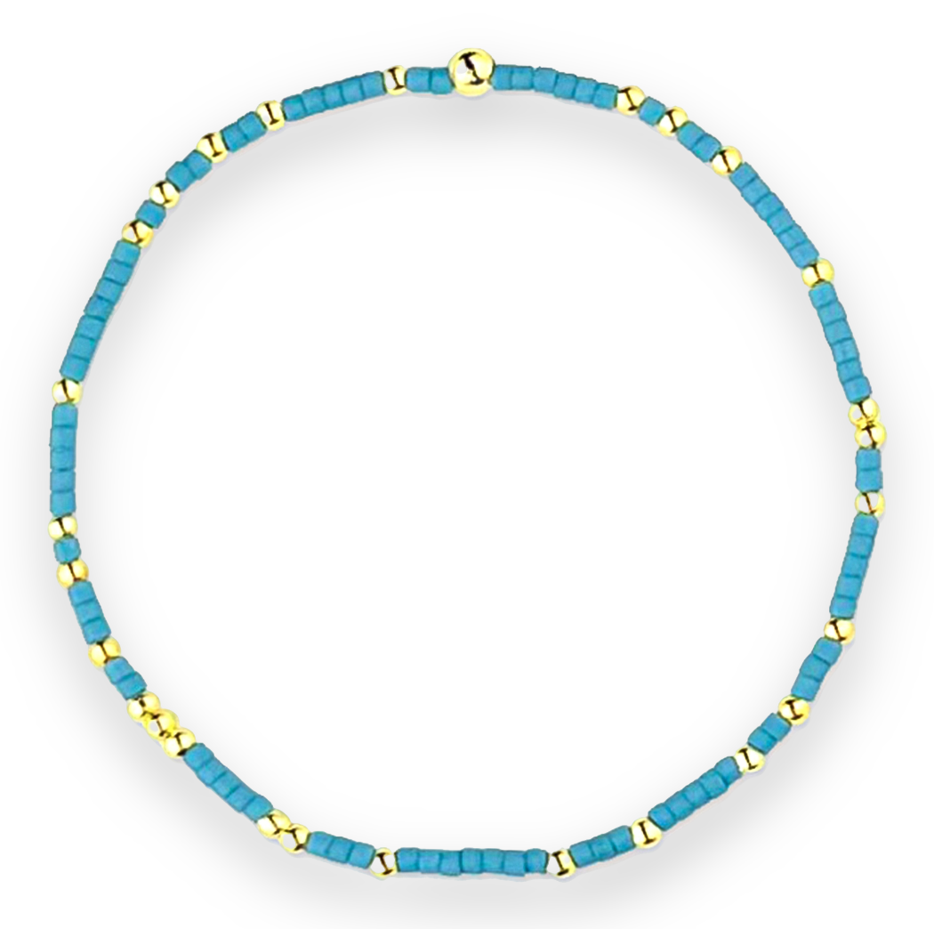 A Bracelet Made With Bayside Blue And Gold Bead